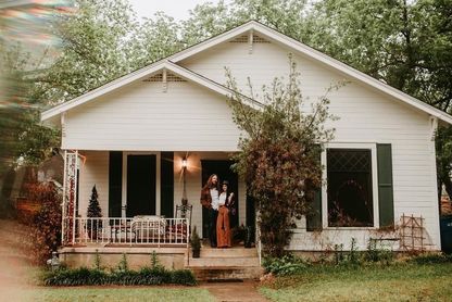 Historic bungalow with charming couple standing on porch, Hyde Park, Austin
